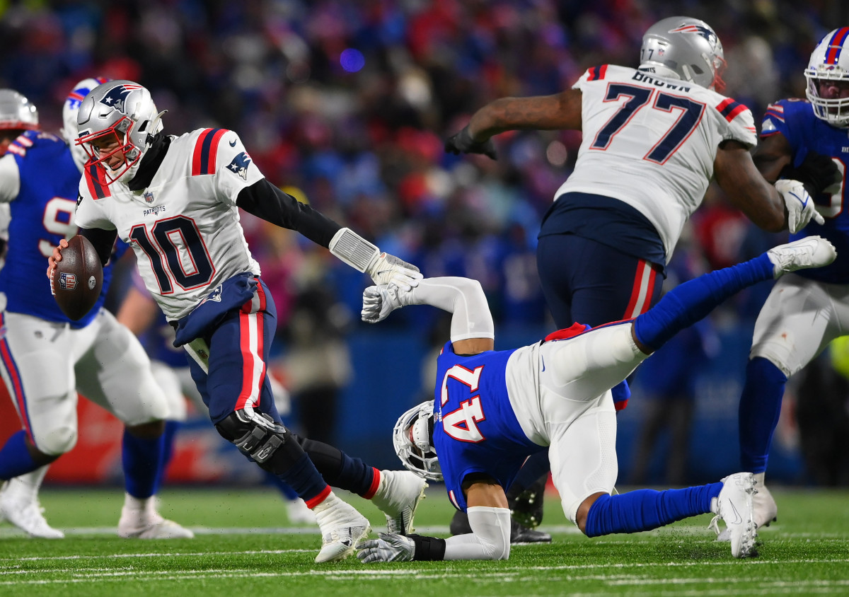 Jan 15, 2022; Orchard Park, New York, USA; New England Patriots quarterback Mac Jones (10) is pressured by Buffalo Bills cornerback Cam Lewis (47) during the fourth quarter of the AFC Wild Card playoff game at Highmark Stadium. The Bills won the game 47-17. 